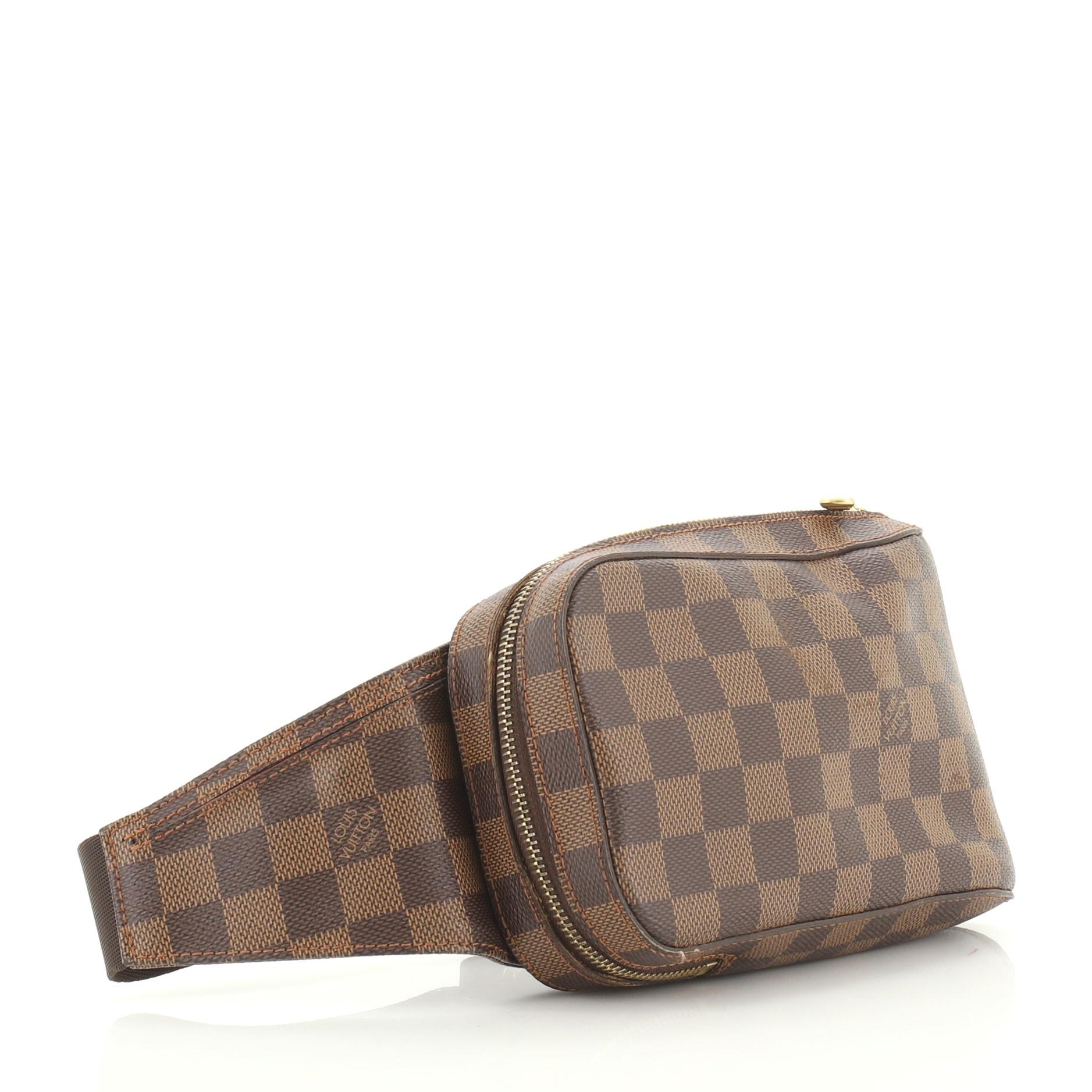 This Louis Vuitton Geronimos Waist Bag Damier, crafted from damier ebene coated canvas, features an adjustable canvas belt strap and gold-tone hardware. Its zip closure opens to an orange fabric interior. Authenticity code reads: CA1005. 

Estimated