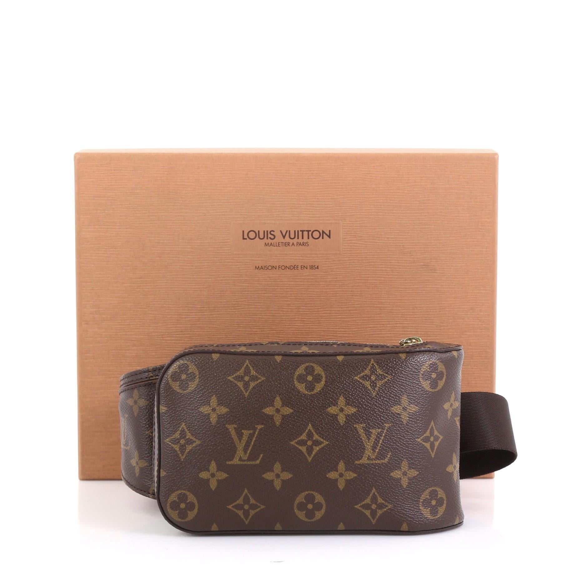 This Louis Vuitton Geronimos Waist Bag Monogram Canvas, crafted from brown monogram coated canvas, features an adjustable brown canvas belt and gold-tone hardware. Its zip closure opens to a brown fabric interior. Authenticity code reads: CA0076.