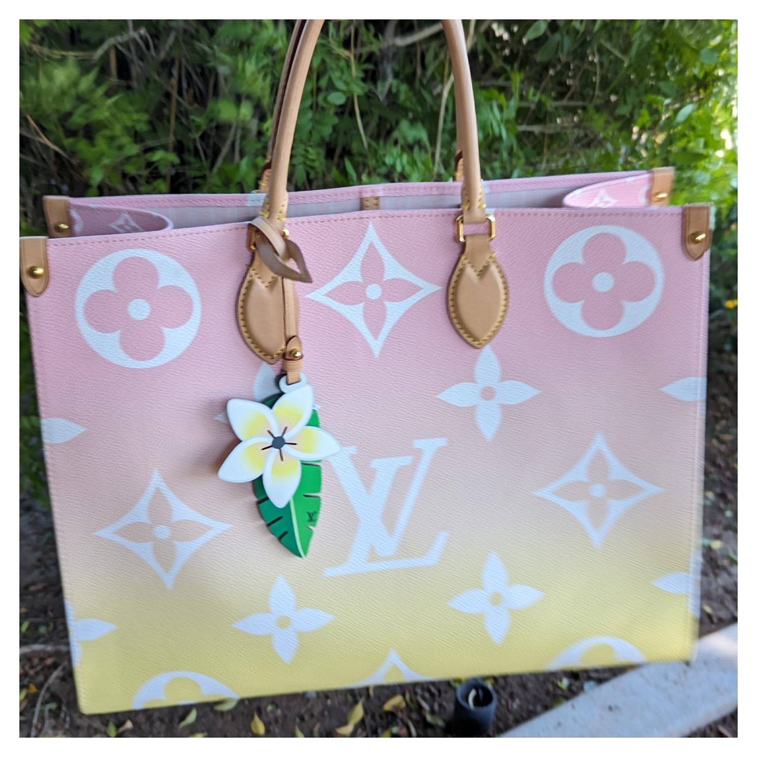 Louis Vuitton Monogram Giant By The Pool Onthego GM in Light Pink. This limited edition tote features oversized and smaller versions of the classic Louis Vuitton monogram printed in white on an ombre pink-to-yellow coated canvas. The bag features