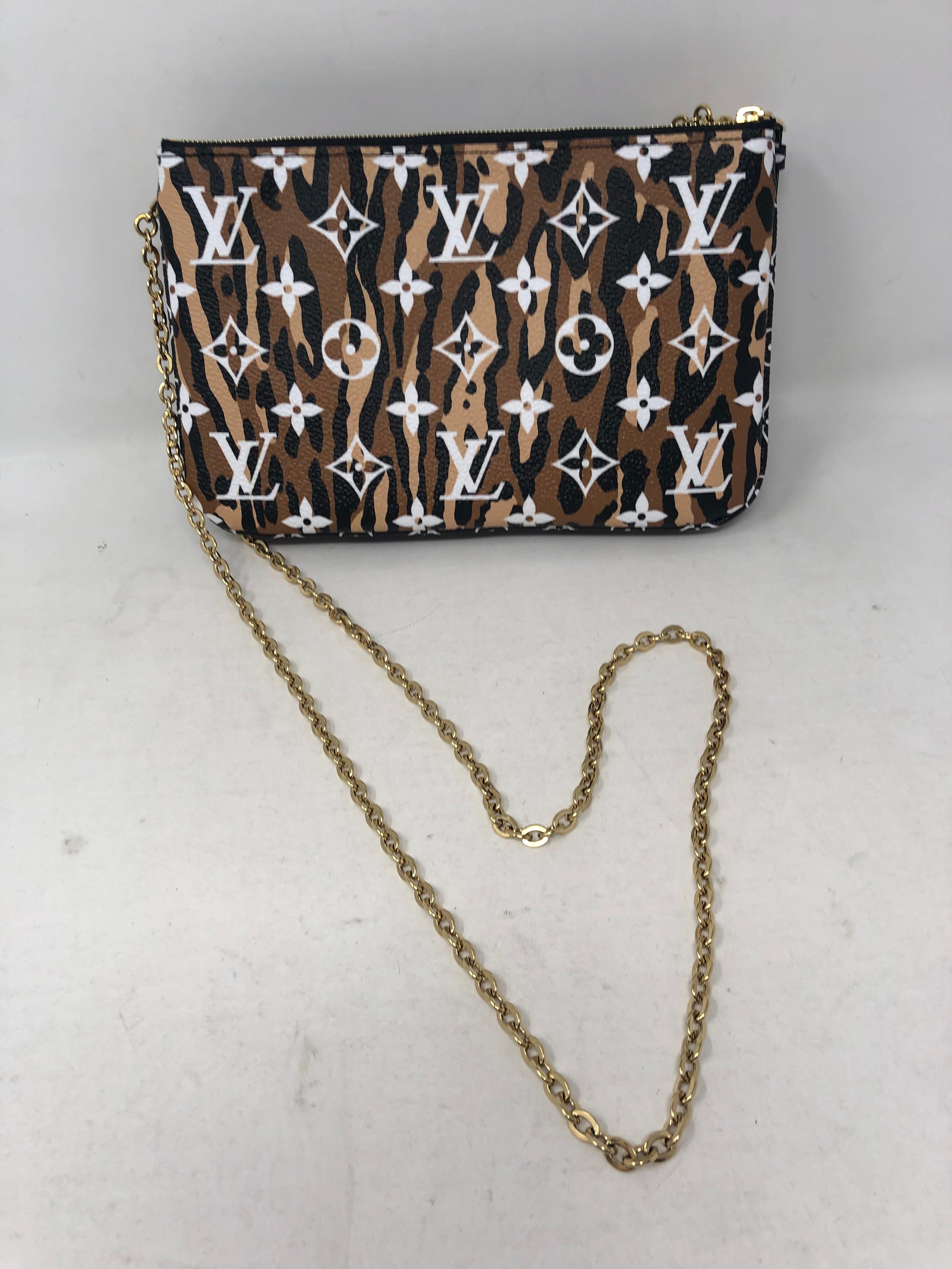Louis Vuitton Giant Jungle Pochette Double Zip Black. Can be worn as a clutch or as a crossbody bag. Long gold chain can be taken off. Plenty of room in the double sections of the pouch. Brand new and sold out at LV. Limited edition. Guaranteed