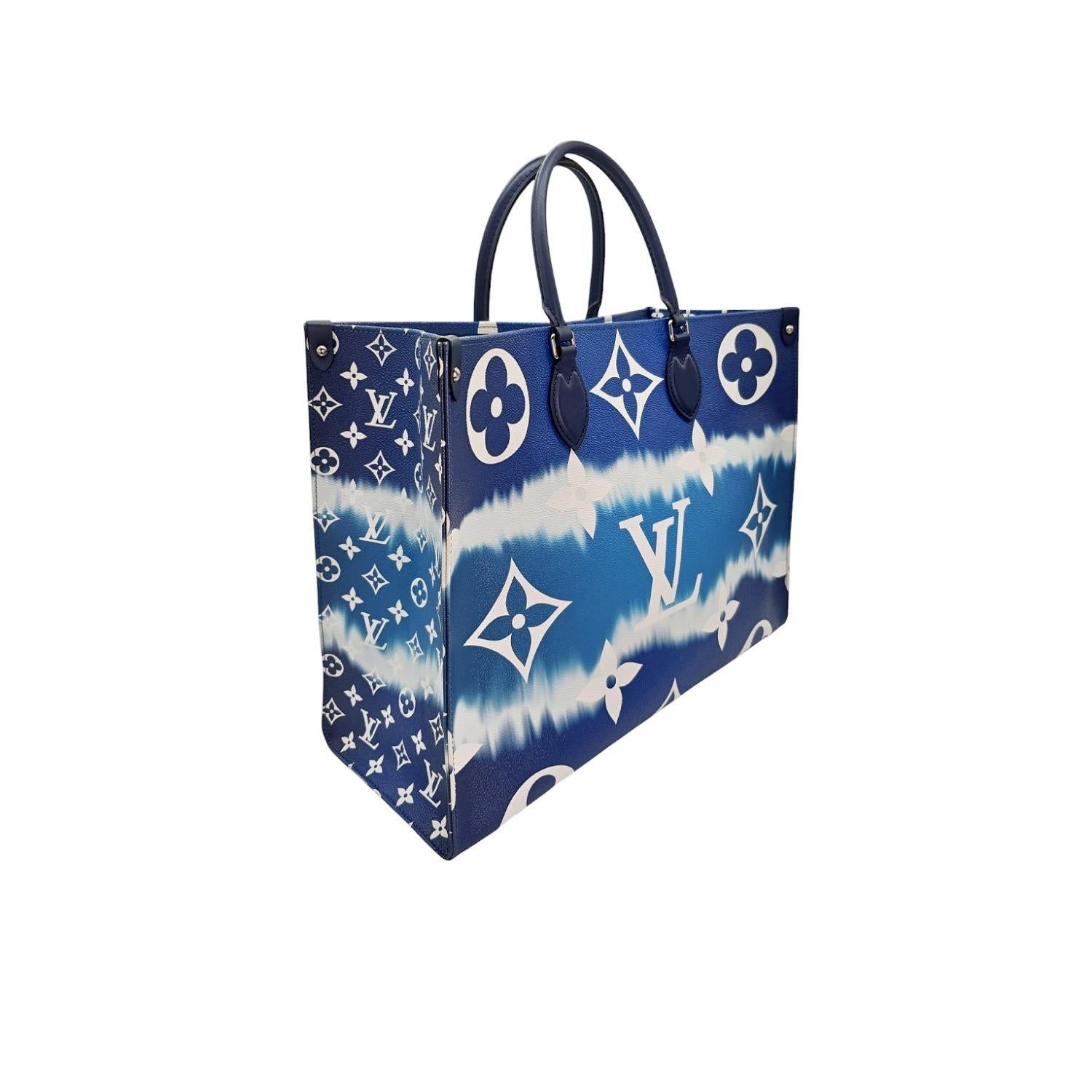 The Louis Vuitton Giant Escale Onthego GM Tote combines luxury and style with its signature monogram pattern in a unique blue tie-dye design. Crafted with leather trim and polished silver hardware, this spacious tote features convertible shoulder