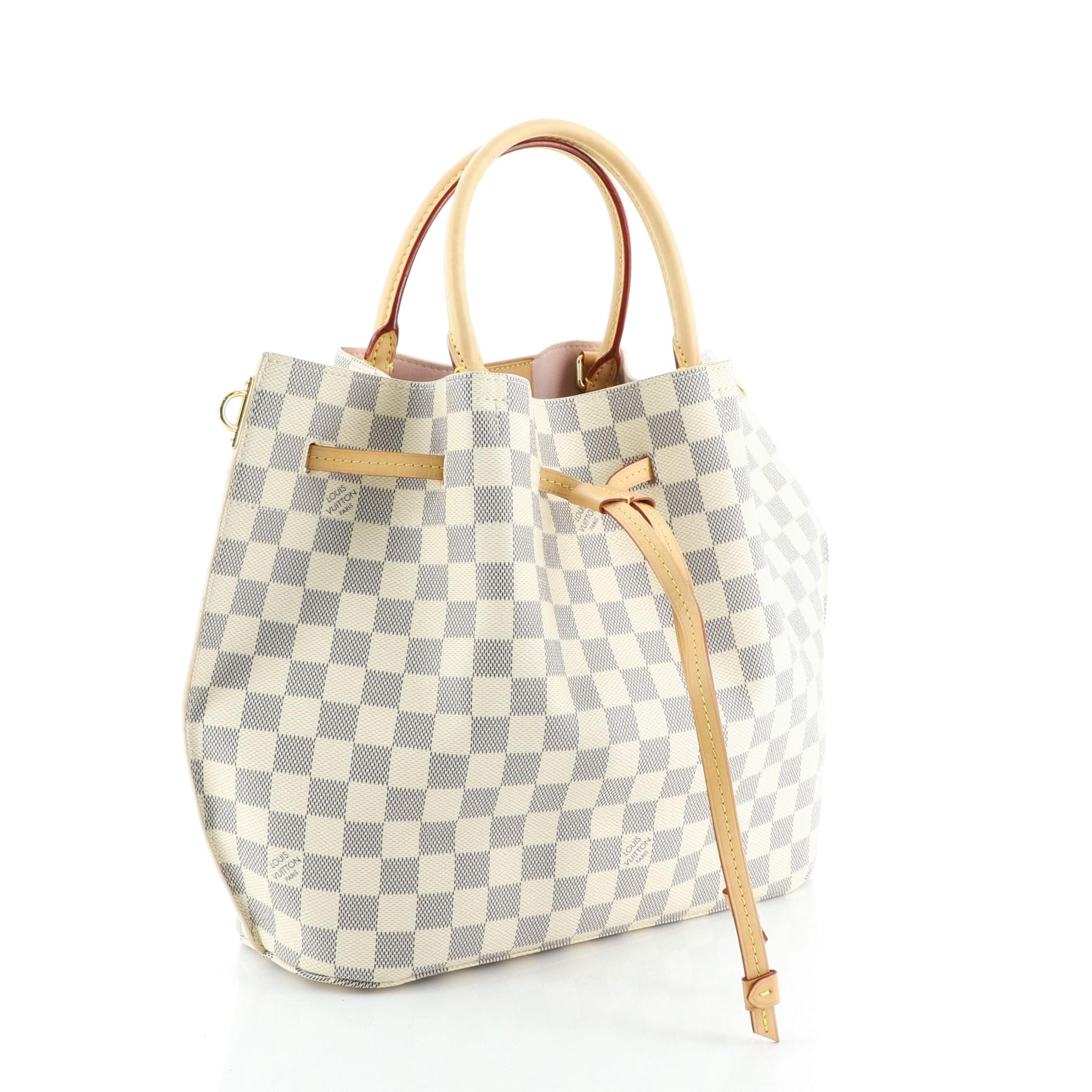 This Louis Vuitton Girolata Handbag Damier, crafted in damier azur coated canvas, features dual rolled handles and gold-tone hardware. Its drawstring closure opens to a pink microfiber interior with side zip pocket. Authenticity code reads: GI3156.