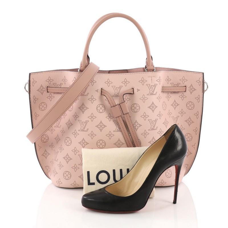This Louis Vuitton Girolata Handbag Mahina Leather, crafted in pink monogram mahina leather with leather trim, features dual rolled leather handles, protective base studs, and silver-tone hardware. Its drawstring leather closure opens to a pink