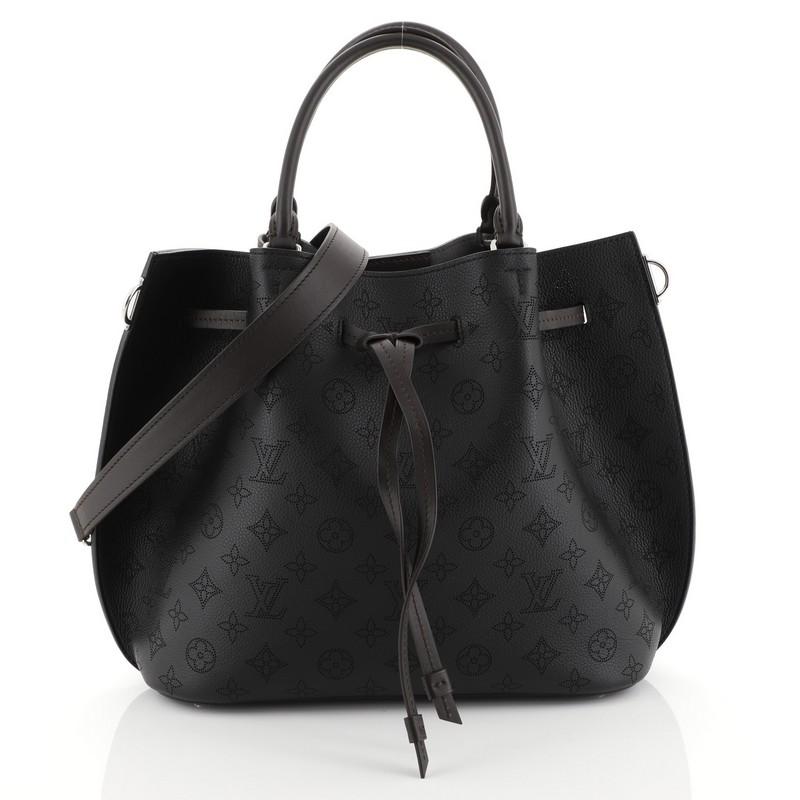 This Louis Vuitton Girolata Handbag Mahina Leather, crafted in black monogram mahina leather, features dual rolled leather handles, protective base studs, and silver-tone hardware. Its drawstring closure opens to a gray microfiber interior with slip