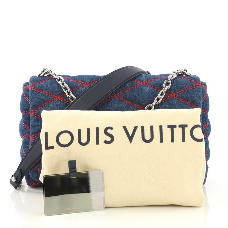This Louis Vuitton GO-14 Handbag Malletage Denim MM, crafted from blue malletage quilted denim, features a chain-link strap with leather shoulder pad and silver-tone hardware. Its twist-lock closure opens to a blue leather interior with slip pocket.