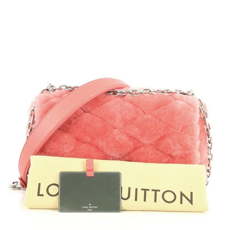 This Louis Vuitton GO-14 Handbag Malletage Fur PM, crafted from pink malletage quilted fur, features a chain link strap with leather shoulder pad and silver-tone hardware. Its twist-lock closure opens to a pink leather interior with slip pocket.