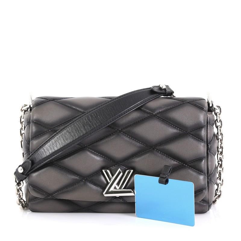 This Louis Vuitton GO-14 Handbag Malletage Leather PM, crafted from gray malletage quilted leather, features a chain-link strap with leather shoulder pad and silver-tone hardware. Its twist-lock closure opens to a black leather interior with slip