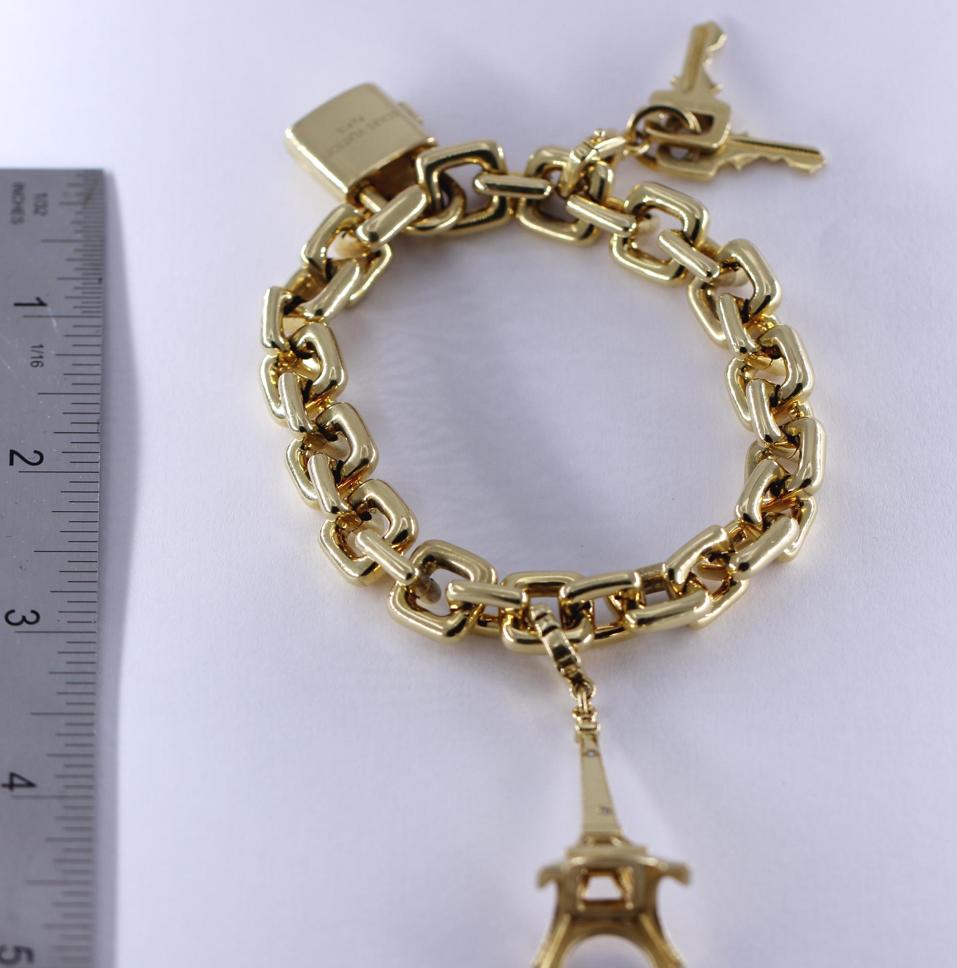 Louis Vuitton Gold Charm Bracelet with Lock and Key Clasp and Eiffel Tower Charm In Good Condition In Palm Beach, FL