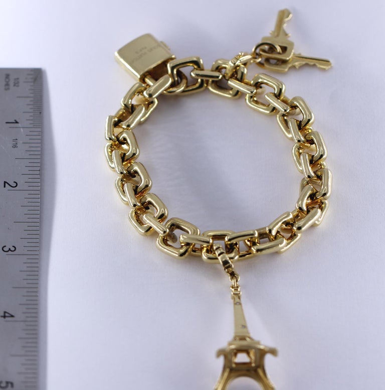 Louis Vuitton Gold Charm Bracelet with Lock and Key Clasp and Eiffel Tower Charm For Sale at 1stdibs