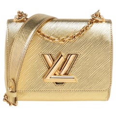 Louis Vuitton Gold Epi Leather Twist PM Bag at 1stDibs  louis vuitton gold  handbag, lv gold purse, gold louis vuitton purse