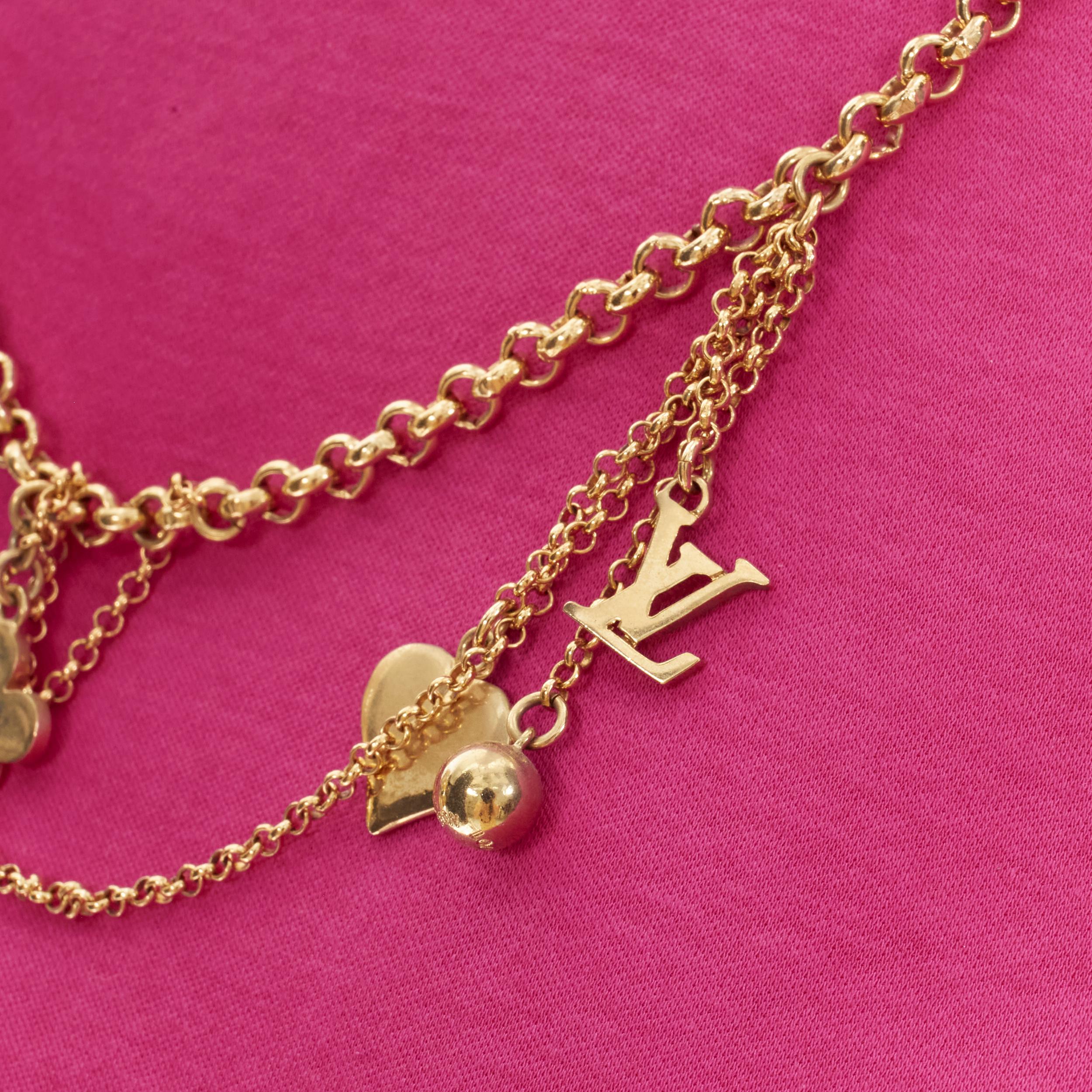 LOUIS VUITTON gold LV charm multi chain ribbon necklace pink cotton tshirt M 
Reference: TGAS/B01401 
Brand: Louis Vuitton 
Material: Cotton 
Color: Pink 
Pattern: Solid 
Extra Detail: Crew neck slim fit Tshirt. LV flower and logo multi charm chain