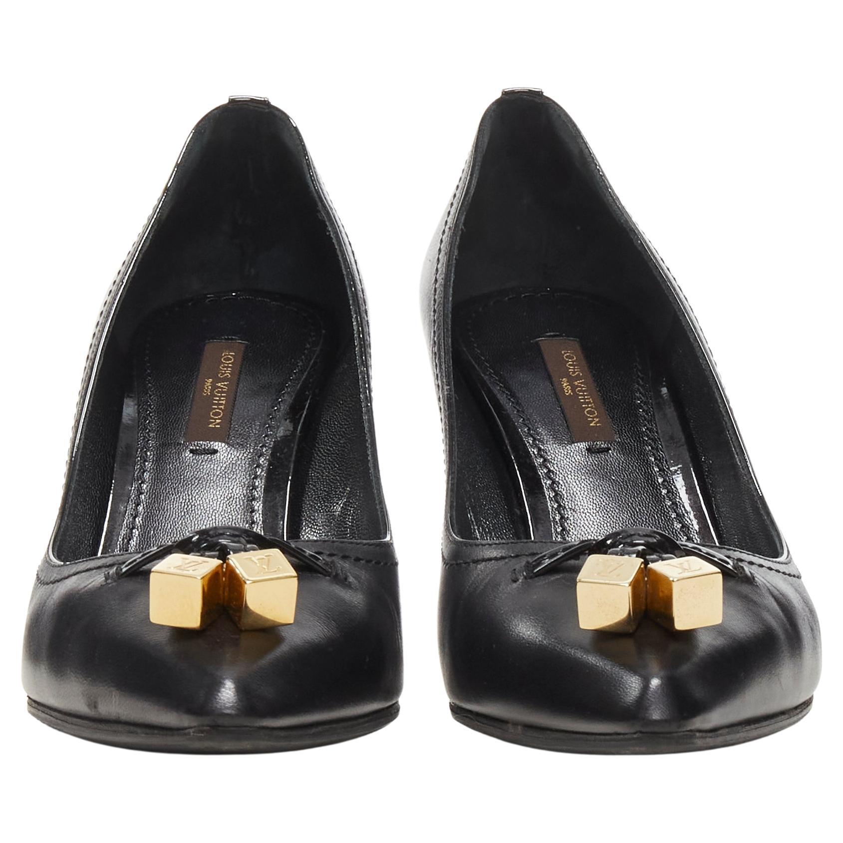 LOUIS VUITTON gold LV dice charm black leather mid heel pump EU36.5
Brand: Louis Vuitton
Material: Leather
Color: Black
Pattern: Solid
Extra Detail: Gold-tone dice charm at vamp. Stacked wooden high heel.
Made in: Italy

CONDITION:
Condition: Very