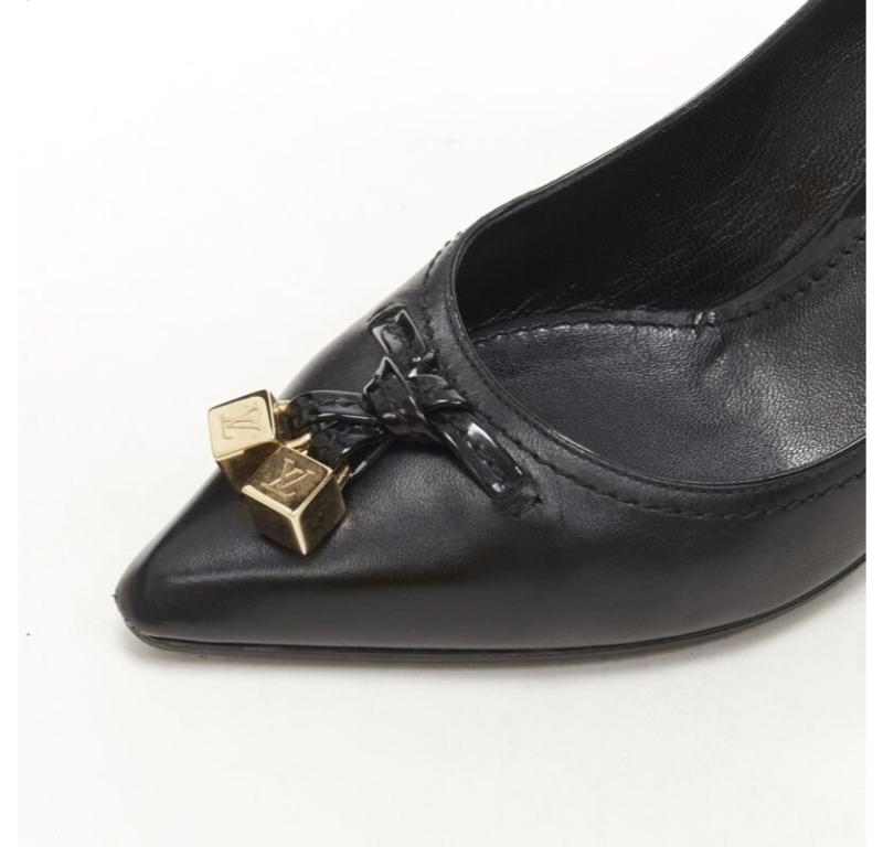 LOUIS VUITTON gold LV dice charm black leather mid heel pump EU36.5
Reference: ANWU/A00960
Brand: Louis Vuitton
Designer: Marc Jacobs
Material: Leather
Color: Black, Gold
Pattern: Solid
Lining:  Leather
Extra Details: Gold-tone dice charm at vamp.