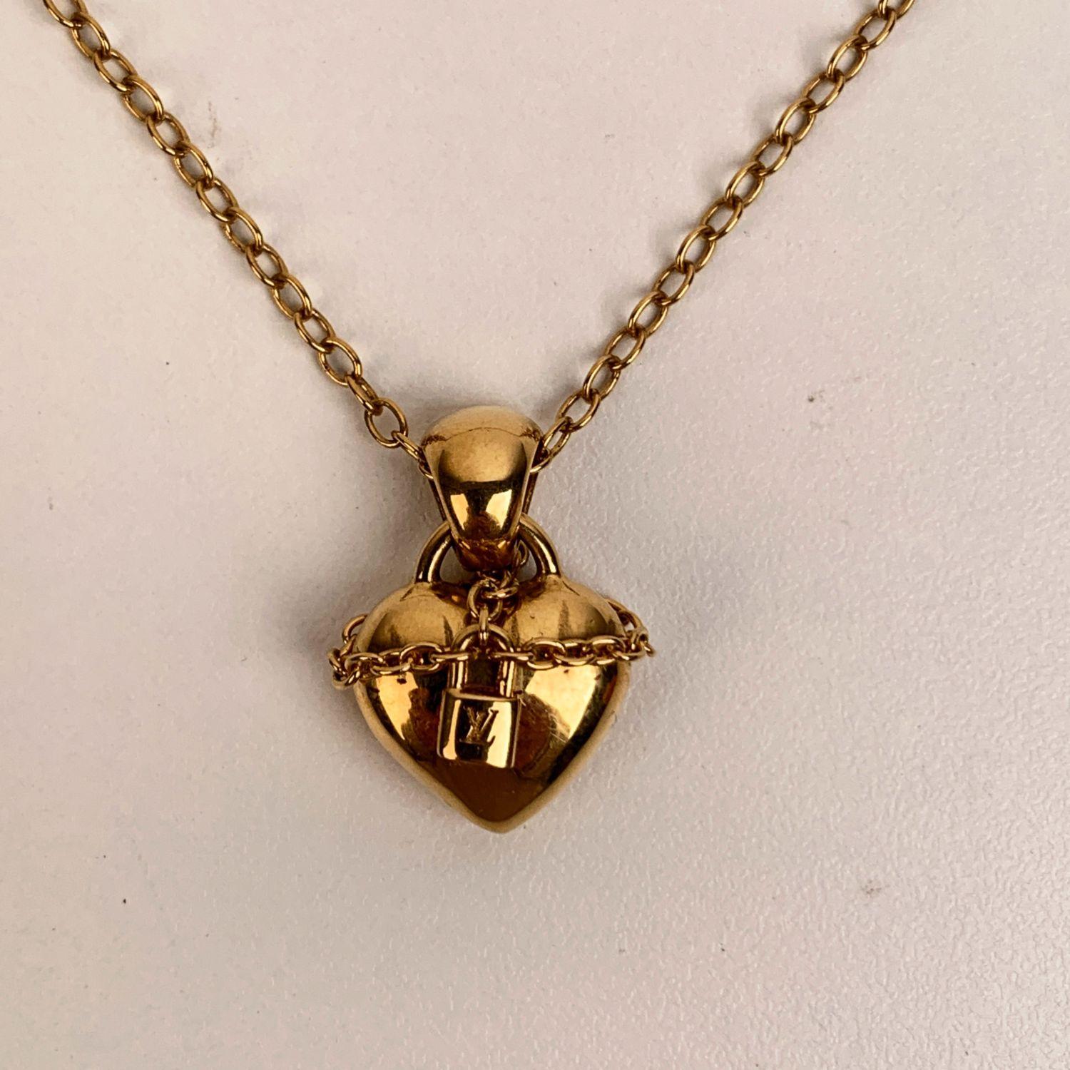 Beautiful Louis Vuitton necklace with heart-shaped pendant with a chain and small padlock with engraved LV initials. It can be worn with 3 different lengths. Clasp closure. 'Louis Vuitton Paris - made in Germany' engraved on oval tab near the