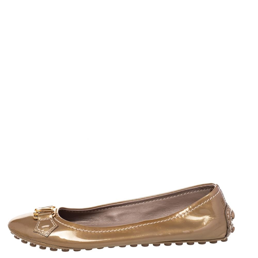 These ballet flats from Louis Vuitton are simple and oh, so cute! They have a patent leather exterior with the signature LV perched on the uppers. The flats are complete with round toes and rubber pebbling on the outsoles.

