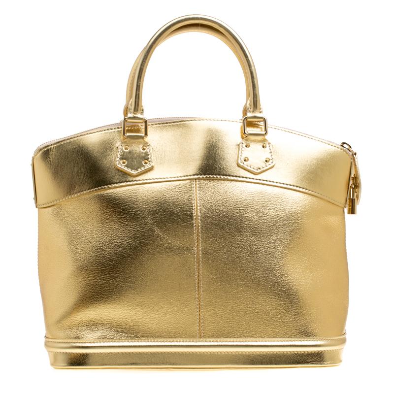 Louis Vuitton's handbags are popular owing to their high style and functionality. This Lockit bag, like all the other handbags, is durable and stylish. Crafted from gold Suhali leather, the bag comes with two rolled top handles and a zipper that