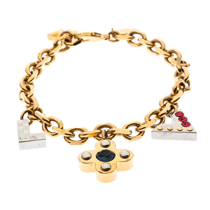 Simple yet elegant, this Louis Vuitton bracelet features a gold-tone metal body detailed with three signature charms. The charms are detailed with crystals as well as studs and they beautifully dangle with every wrist movement. The bracelet can be