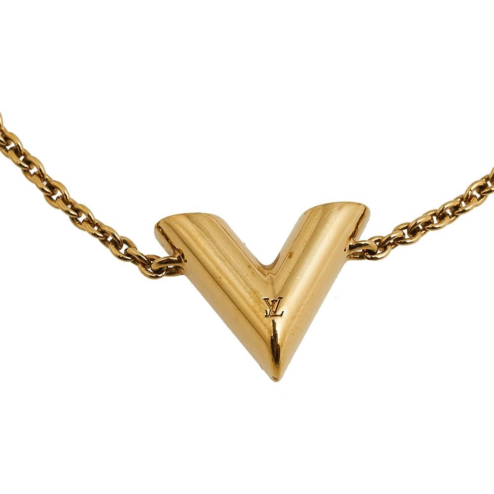 Create an elegant, timeless, and classic addition to both casual and even special events with this beautiful Louis Vuitton Essential V bracelet. Constructed in gold-tone metal, this bracelet features a large V charm in the center with LV carving and