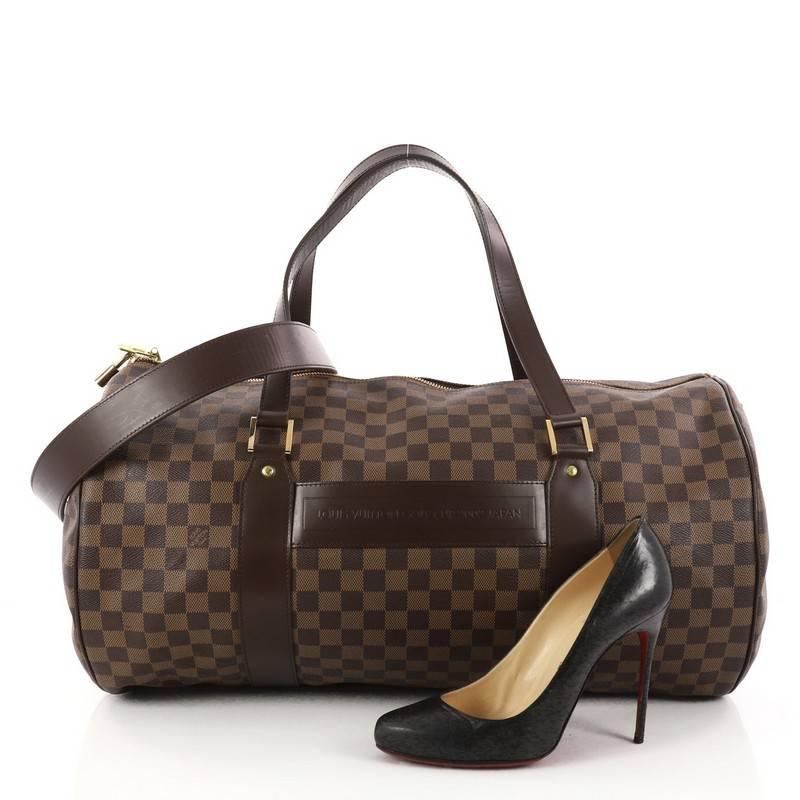 This authentic Louis Vuitton Golf Cup Sac Polochon Duffle Damier is a rare VIP item from the Japan Golf Cup 2002. Crafted in damier ebene coated canvas, this stylish bag features dual-flat leather handles, smooth brown leather trims, Marked 