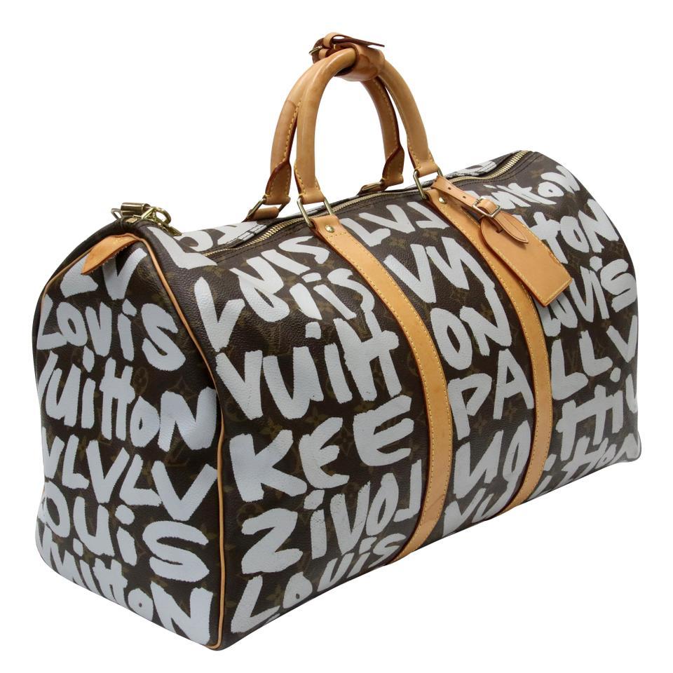 Don't miss out on your opportunity to own this rare and limited edition Louis Vuitton Limited Edition Grey Graffiti Stephen Sprouse Keepall 50 Bag. This popular Keepall 50 has the iconic monogram canvas adorned with grey graffiti. With its