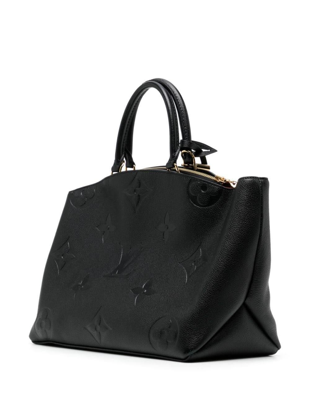 * Black
* Empreinte leather
* All-over debossed logo print
* Two rolled top handles
* Detachable shoulder strap
* Top zip fastening
* Main compartment
* Internal zip-fastening pocket
* Multiple internal slip pockets
* Gold-tone hardware
* Excellent
