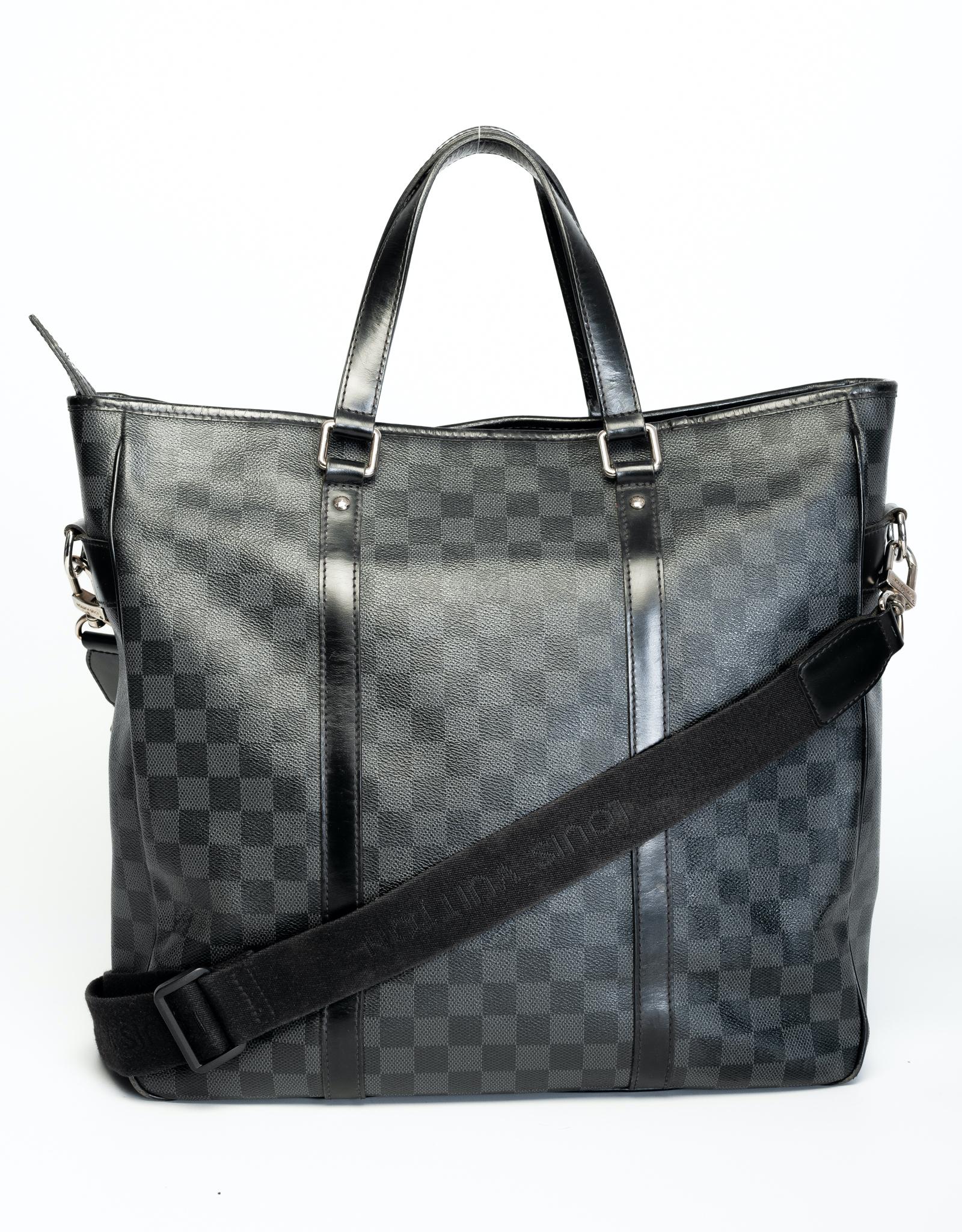 This LV Tadao bag from the from the 2011 Collection is made with Damier Graphite coated canvas and features silver-tone hardware, black leather trim, detachable logo shoulder strap, dual rolled leather top handles and black woven fabric interior