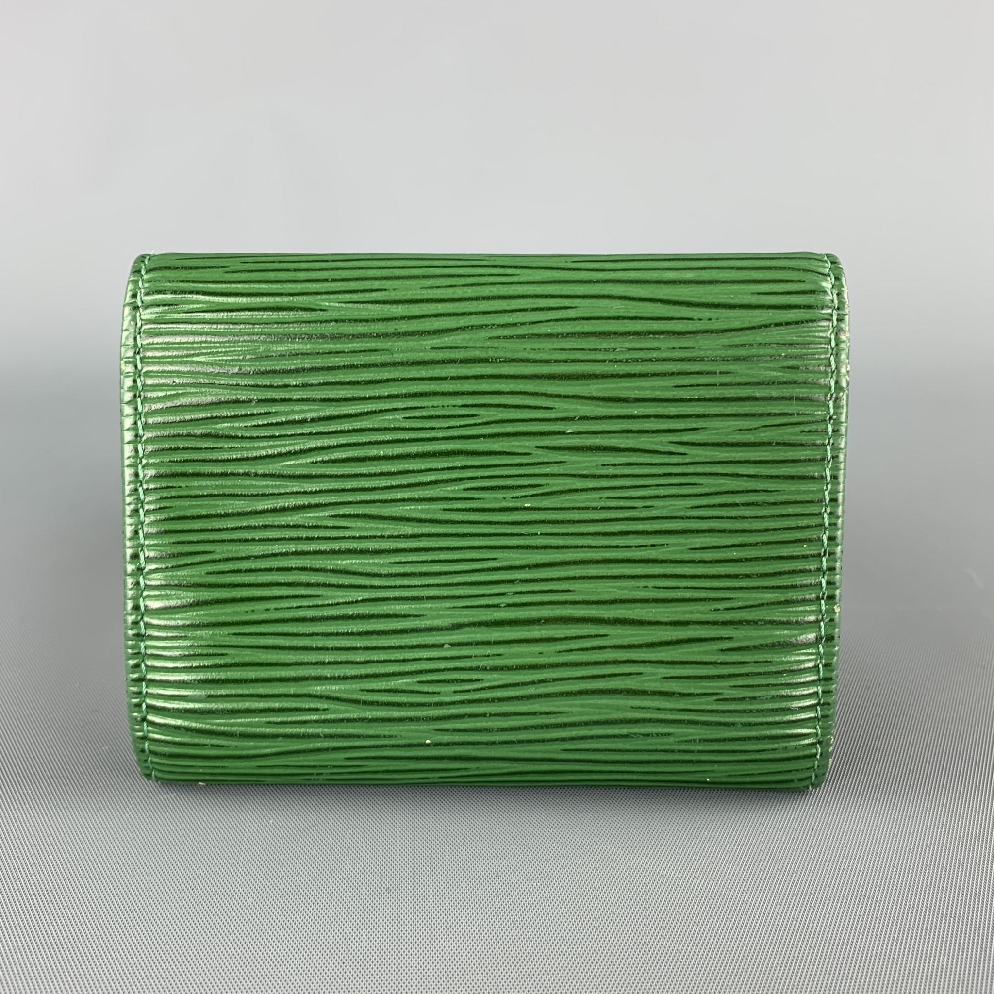 LOUIS VUITTON wallet comes in green Epi leather with a top flap snap closure, frontal card slot, and coin purse interior. Wear throughout. Made in Spain. 

Very Good Pre-Owned Condition.
Marked: CA0958

10 x 8 cm.

SKU: 104104