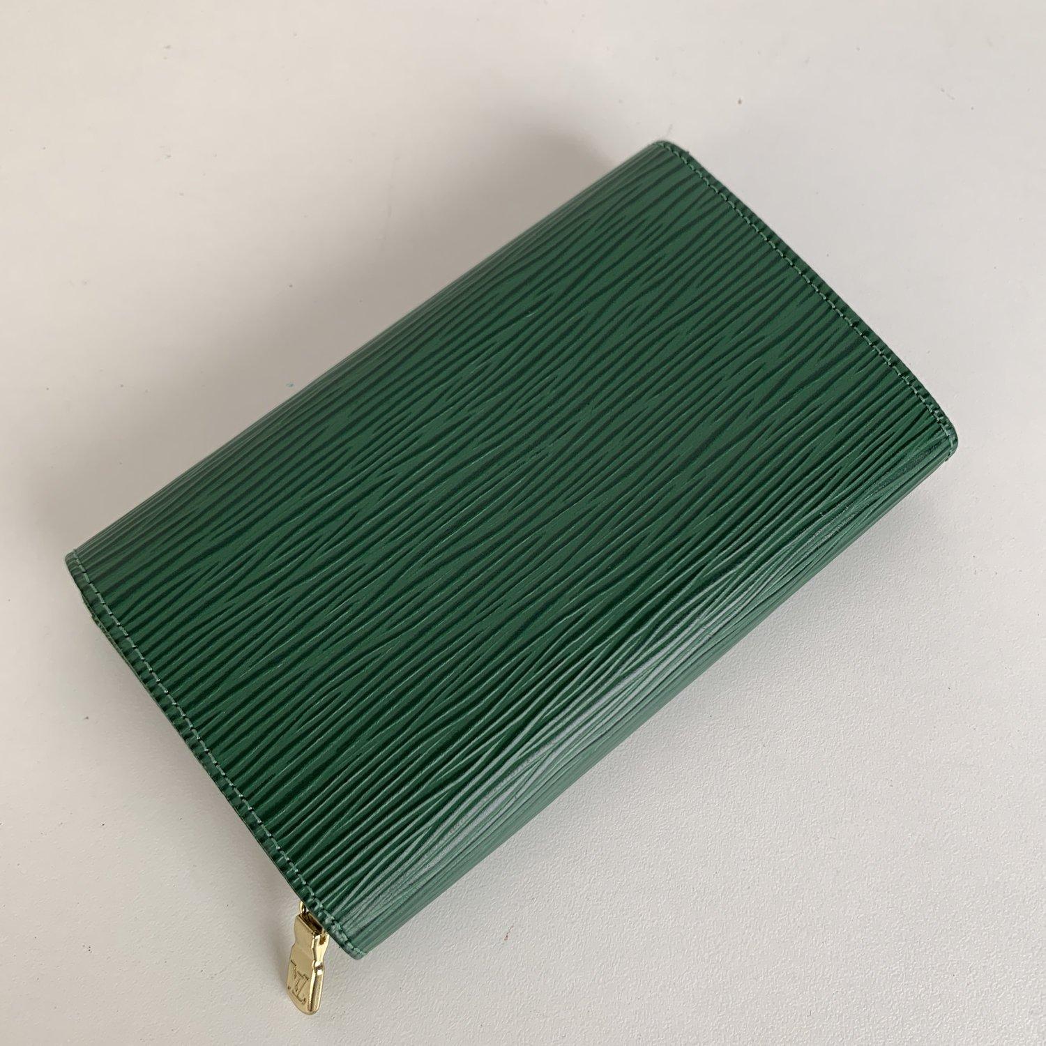 Louis Vuitton Green Epi Leather Porte-Monnaie Tresor Wallet. Snap flap closure. LV - LOUIS VUITTON logo embossed on the flap. 2 open pockets on the reverse of the flap. Leather lining. 2 main compartments inside. 1 middle zip compartment . 'LOUIS