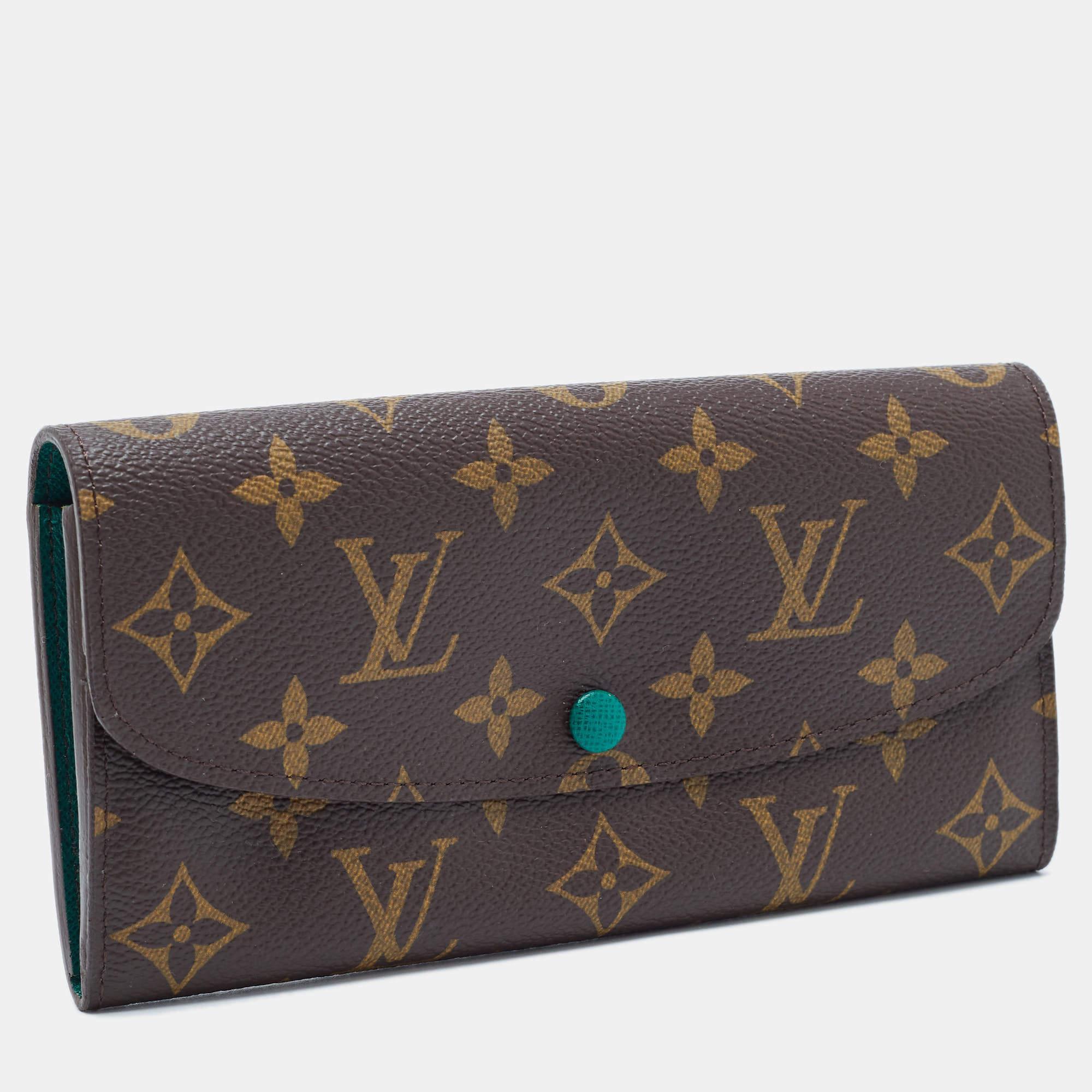 Handy and stylish, this Emilie wallet is from the house of Louis Vuitton. Made from Monogram canvas, the buttoned closure opens to an expanse with compartments to arrange currency, bills and a zip coin pocket. Perfect in size, it can easily fit