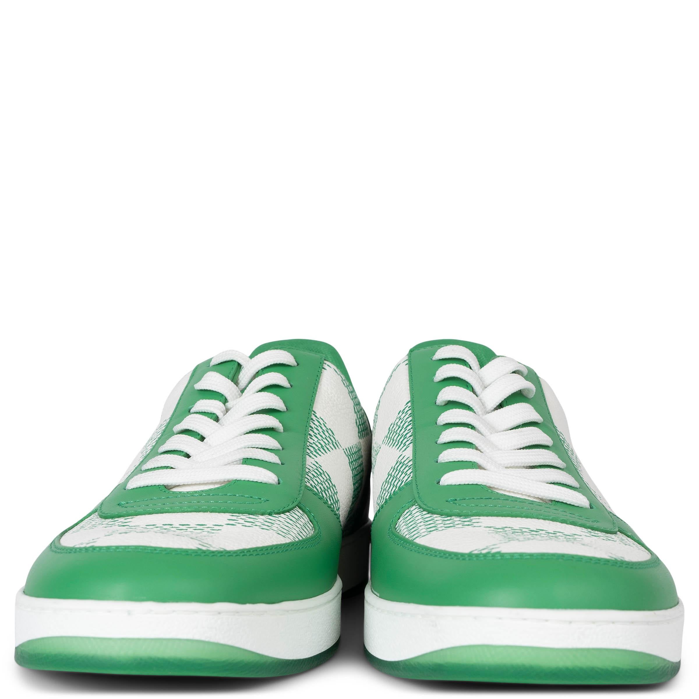 These 100% authentic Louis Vuitton Rivoli low-top sneakers in white and green Damier canvas blend sporty style with luxury craftsmanship. They feature green leather trims, round toes, and white laces, all set atop white and green rubber soles for a