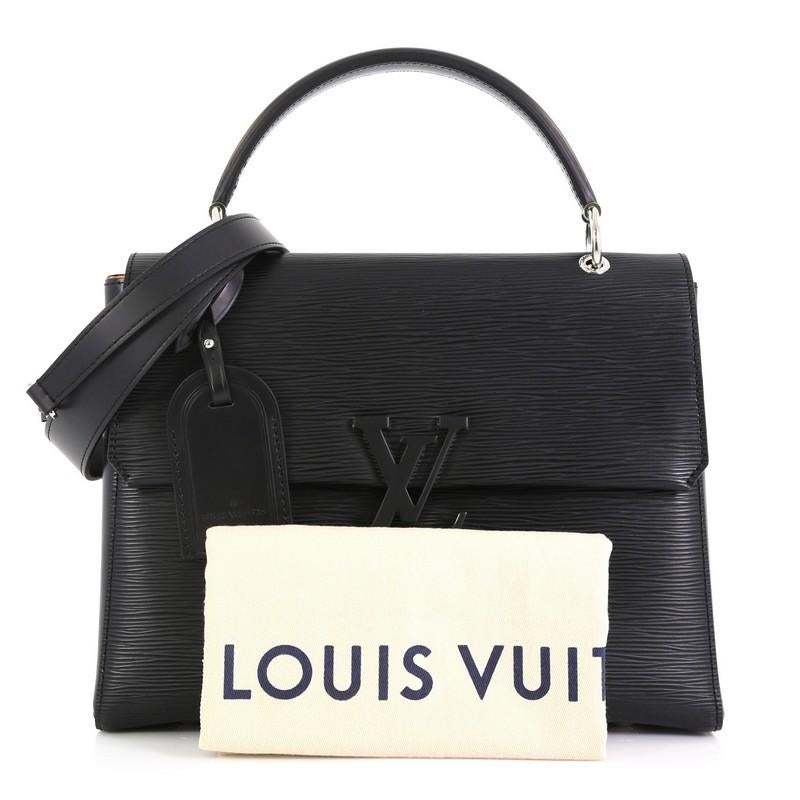 This Louis Vuitton Grenelle Handbag Epi Leather MM, crafted in black epi leather, features a leather top handle, tone-on-tone LV signature, and silver-tone hardware. Its magnetic closure opens to a yellow microfiber interior with zip pocket.