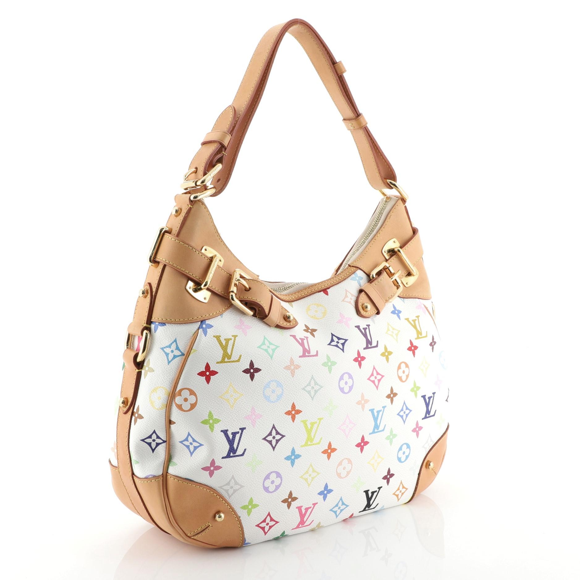 This Louis Vuitton Greta Handbag Monogram Multicolor, crafted in white multicolor monogram coated canvas, features an adjustable strap, cowhide leather trim, and gold-tone hardware. Its zip closure opens to a red microfiber interior with side zip