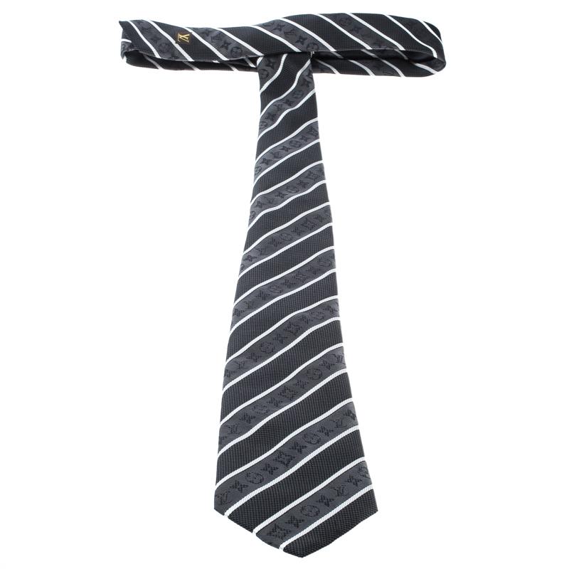 Brimming with signature details, this tie by Louis Vuitton will add a subtle touch to your formal attire. It is cut from silk and styled with a grey and black striped design all over accented with monogram details and the signature Damier pattern