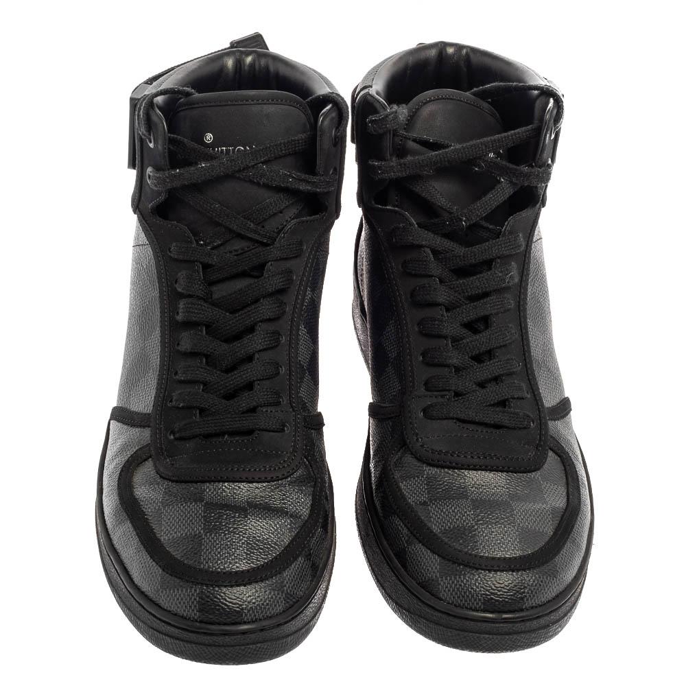 These Louis Vuitton high-top sneakers are trendy and stylish. Richly crafted in Italy from quality leather and Damier Graphite canvas, they are sure to make a dream buy. These Rivoli sneakers have signature-printed velcro straps, laces, and