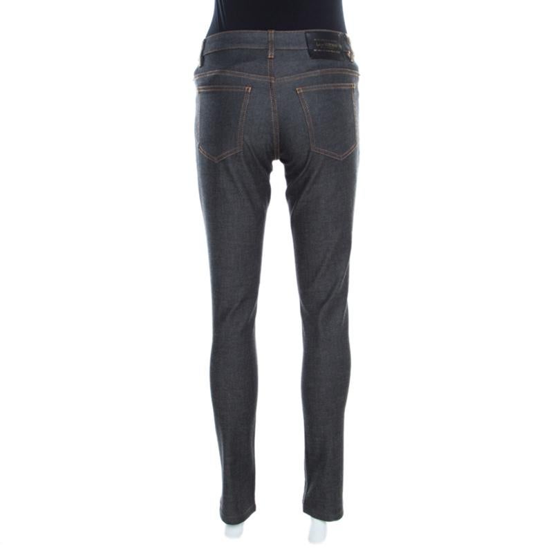 These straight fit jeans from Louis Vuitton are just perfect to be flaunted by you! The grey dark wash jeans are made of a cotton blend. They flaunt a front button fastening and belt loops. They come equipped with four external pockets and are sure