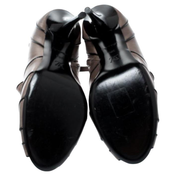 Questi stivaletti Marlene di Louis Vuitton sono impreziositi da un interessante motivo sulla tomaia e sono fissati da fibbie. Realizzate in Italia in pelle grigia, hanno un tacco di 10 cm e sono dotate di punta a lancia. Che tu le indossi con i