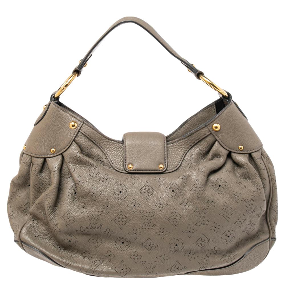 This stylish bag by Louis Vuitton will make all your handbag dream come true! This Solar PM bag has been crafted from Monogram Mahina leather and comes in a stunning shade of grey. It has a single handle, a strap closure with a gold-tone push-lock.