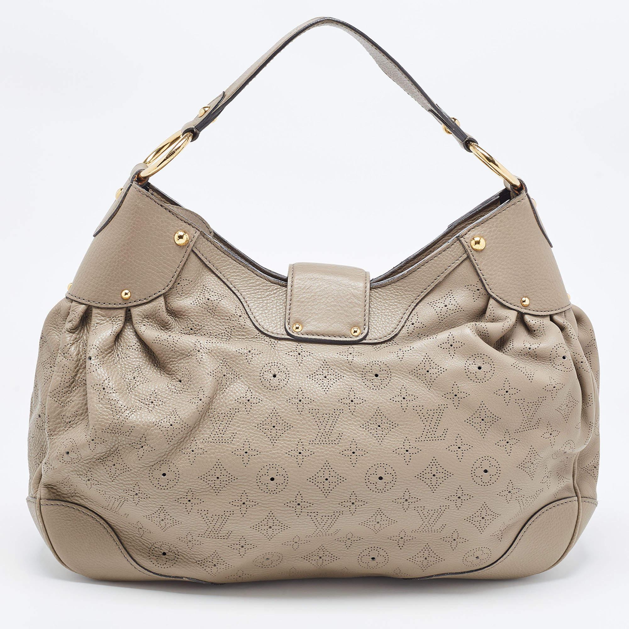 This stylish bag by Louis Vuitton will make all your handbag dream come true! This Solar PM bag has been crafted from Monogram Mahina leather and comes in a stunning shade of grey. It has a single handle, a strap closure with a gold-tone push-lock.