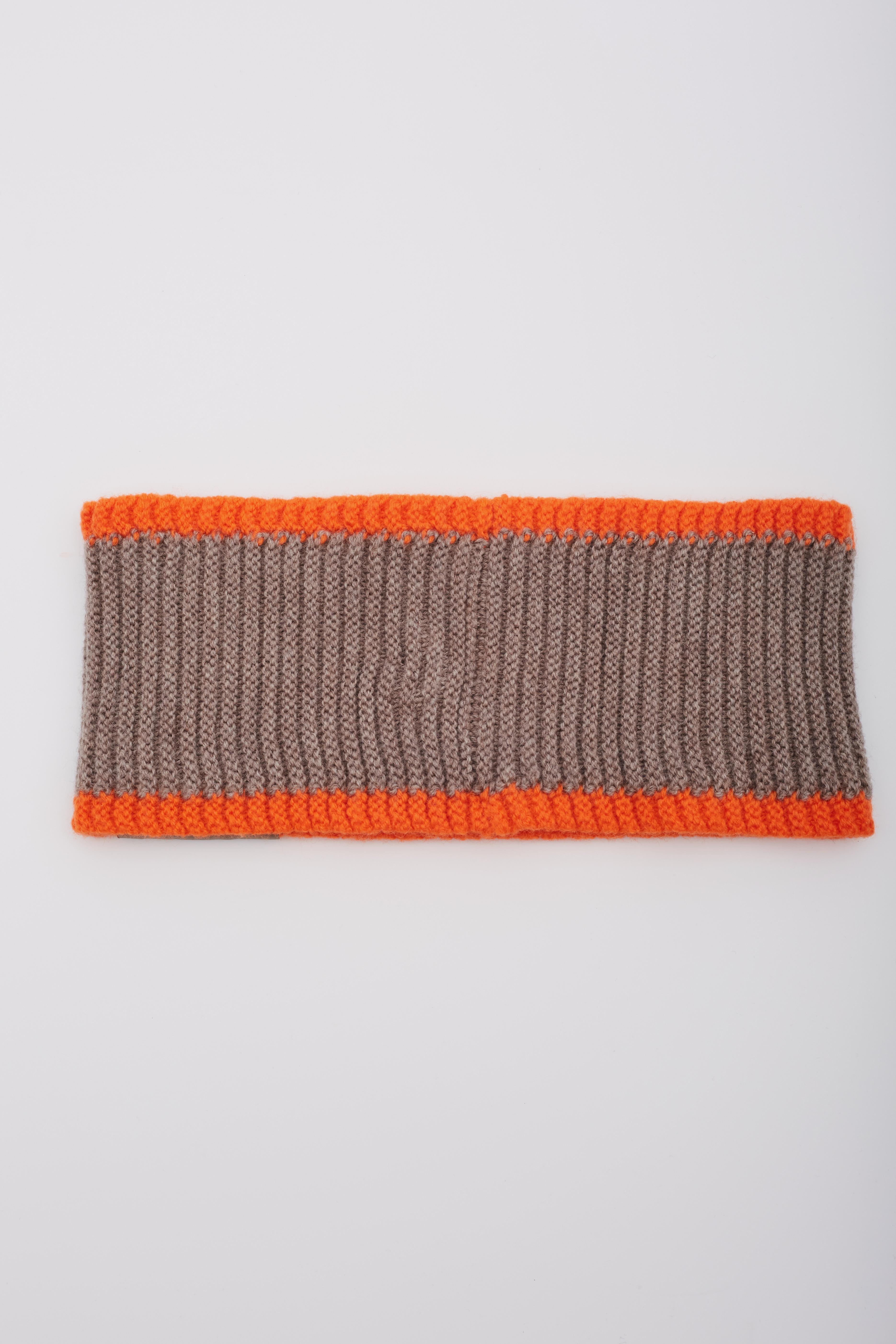Ce bandeau Louis Vuitton est réalisé en laine grise tricotée avec un motif côtelé. Le bandeau est bien ajusté et comporte un grand logo LOUIS orange et noir tricoté sur le devant, une bande orange côtelée sur les bords et une petite étiquette grise