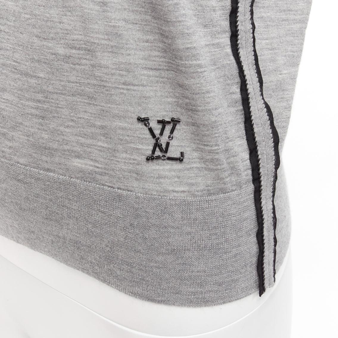 LOUIS VUITTON grey soft knit black beaded LV logo V neck pullover top
Reference: NILI/A00021
Brand: Louis Vuitton
Material: Fabric
Color: Grey, Black
Pattern: Solid
Closure: Pullover
Extra Details: LV beaded logo at left