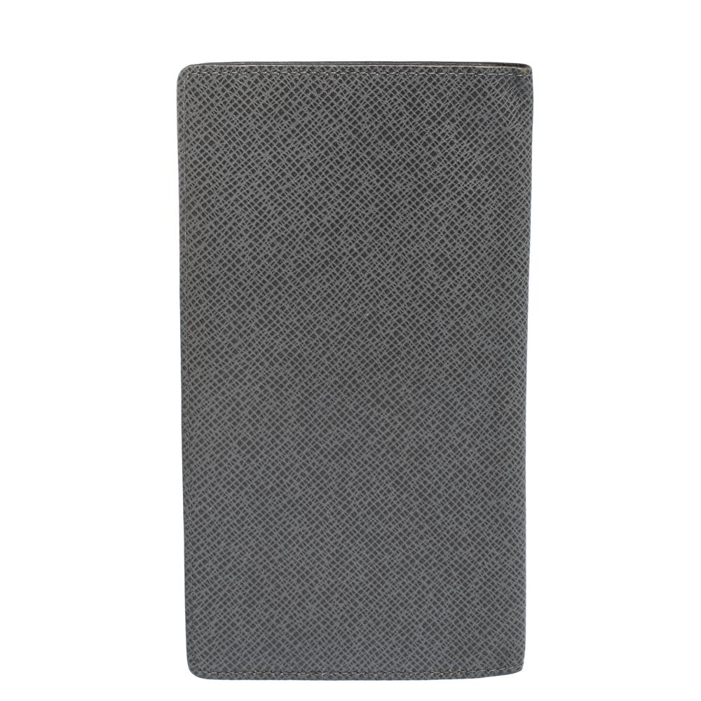 The Brazza wallet by Louis Vuitton will instantly become your favourite. It comes with multiple credit card slots, bill compartment, and pockets. Made from grey Taiga leather, the wallet is designed in a sleek shape that fits neatly in your