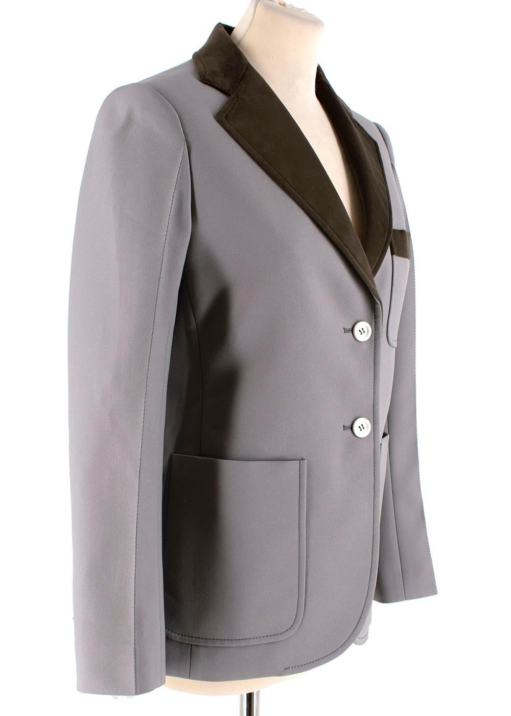 Louis Vuitton Grey Tailored Jacket with Velvet Trim

- Thick structured grey material
- Velvet green revere collar
- Dark grey top stitching
- White LV embossed buttons
- Open pockets x3
- Velvet logo & 3 white matte buttons on the cuffs
- Black