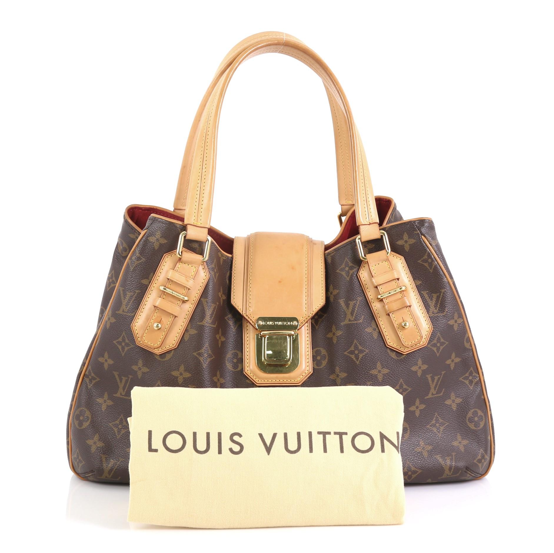 This Louis Vuitton Griet Handbag Monogram Canvas, crafted in brown monogram coated canvas, features dual leather handles and trim, protective base studs, and gold-tone hardware. Its top flap with push-lock closure opens to a red microfiber interior