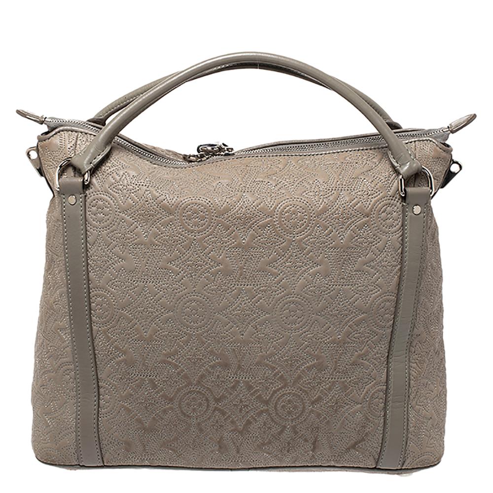 Louis Vuitton's handbags are popular owing to their high style and functionality. This Antheia Ixia PM bag, like all the other handbags, is durable and stylish. Crafted from Gris Clair monogram leather, the grey bag can be paraded using the top