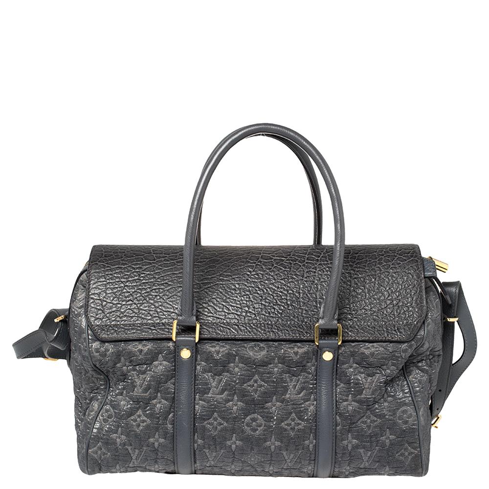 This bag is from Louis Vuitton's Fall/Winter 2010 Runway Collection. It is a limited edition piece made from monogram coated canvas and detailed with a leather flap. On top, there are two handles and on the base, there are four metal