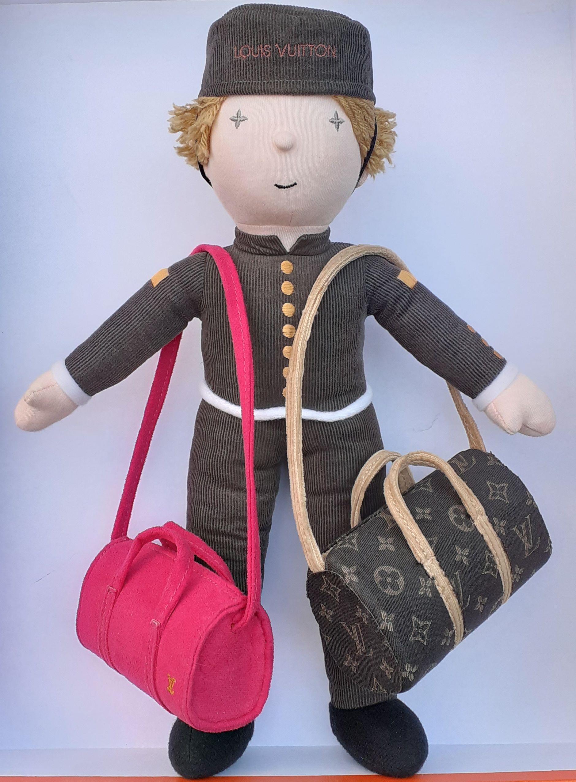 Rare Louis Vuitton Doll

Given to the VIP customers by the Brand

Bellboy Groom Shaped

Carrying 2 Keepall Bags: one brown with LV monogramm all over, one fuchsia pink with LV monogramm in yellow sewn at right lower corner

The doll and the pink ba