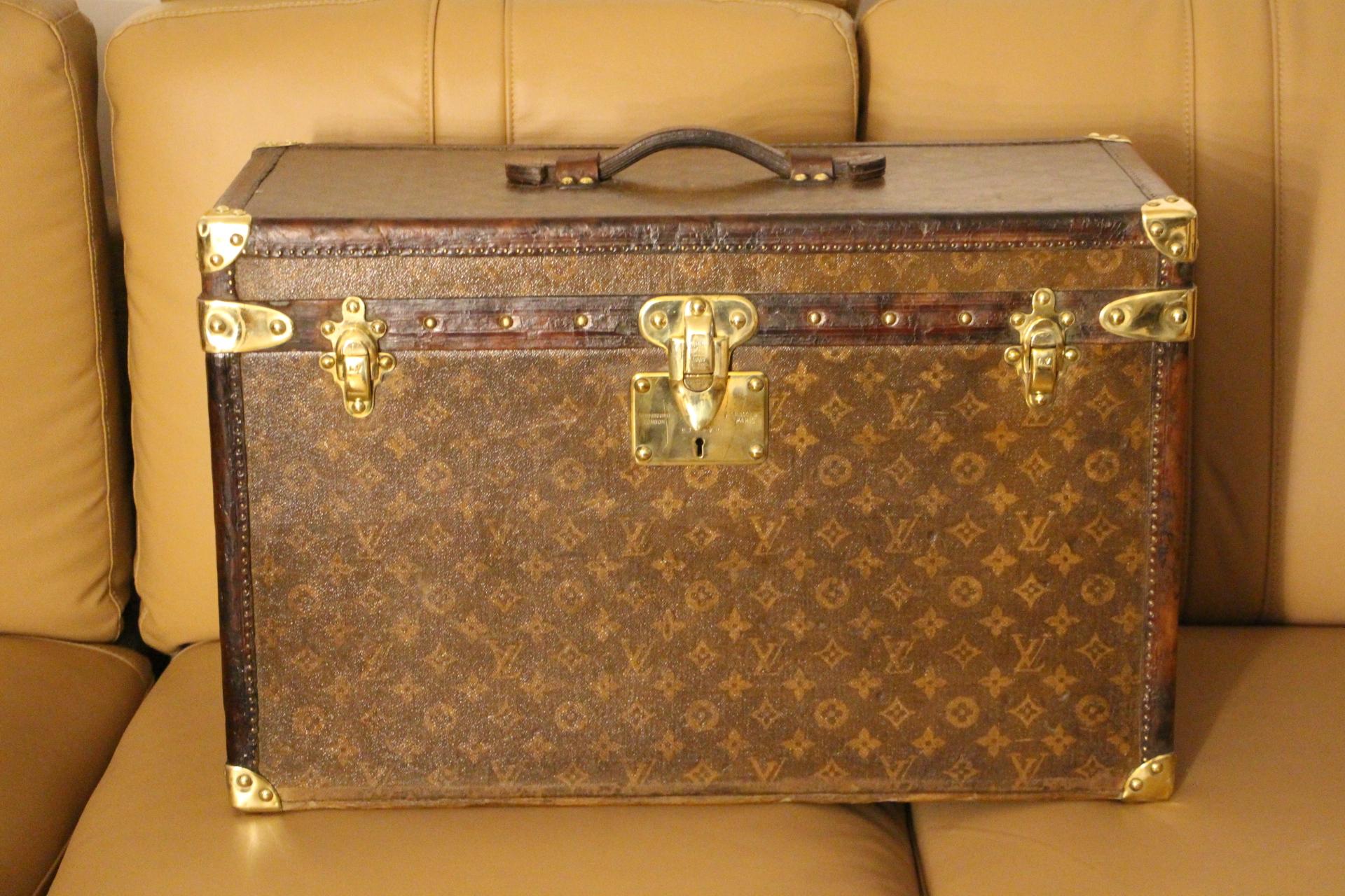 This Louis Vuitton trunk is very unusual by its dimensions. It features stenciled monogram canvas and also beautiful all leather trim in chocolate color. It still has got its painted customized french flag on each side.
Solid brass Louis Vuitton