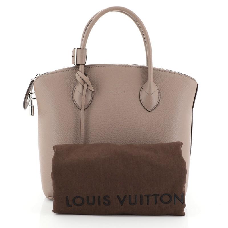 This Louis Vuitton Haute Maroquinerie Lockit Handbag Leather PM, crafted in neutral leather, features dual-rolled leather handles, iconic Lockit shape that combines both form and function, protective base studs and silver-tone hardware accents. Its