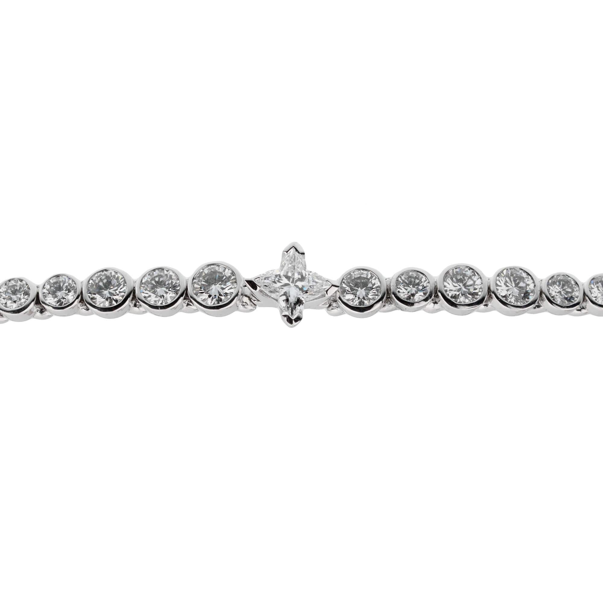 An incredible tennis bracelet by Louis Vuitton showcasing alternating sized round brilliant cut diamonds, iconic Les Ardentes shaped central diamond and baguette diamonds in shimmering 18k white gold.

5ct Appx Diamond Weight