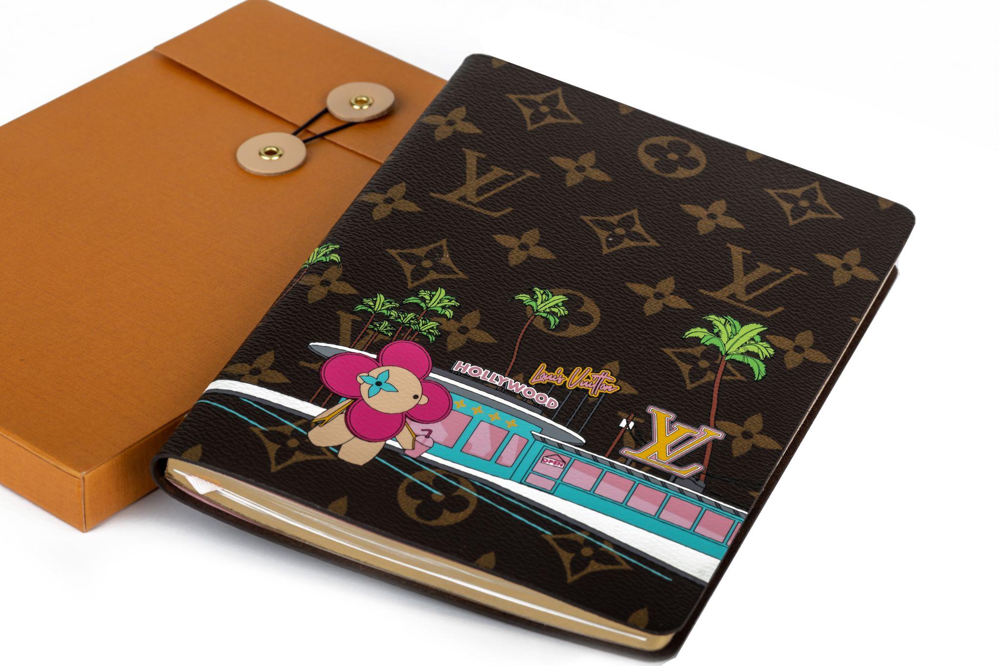 The Louis Vuitton Hollywood Xmas Clémence Notebook is a practical accessory that exudes a lighthearted spirit. It is crafted from Monogram canvas and decorated with playful illustrations of the Vivienne mascot and an adorable teddy bear enjoying
